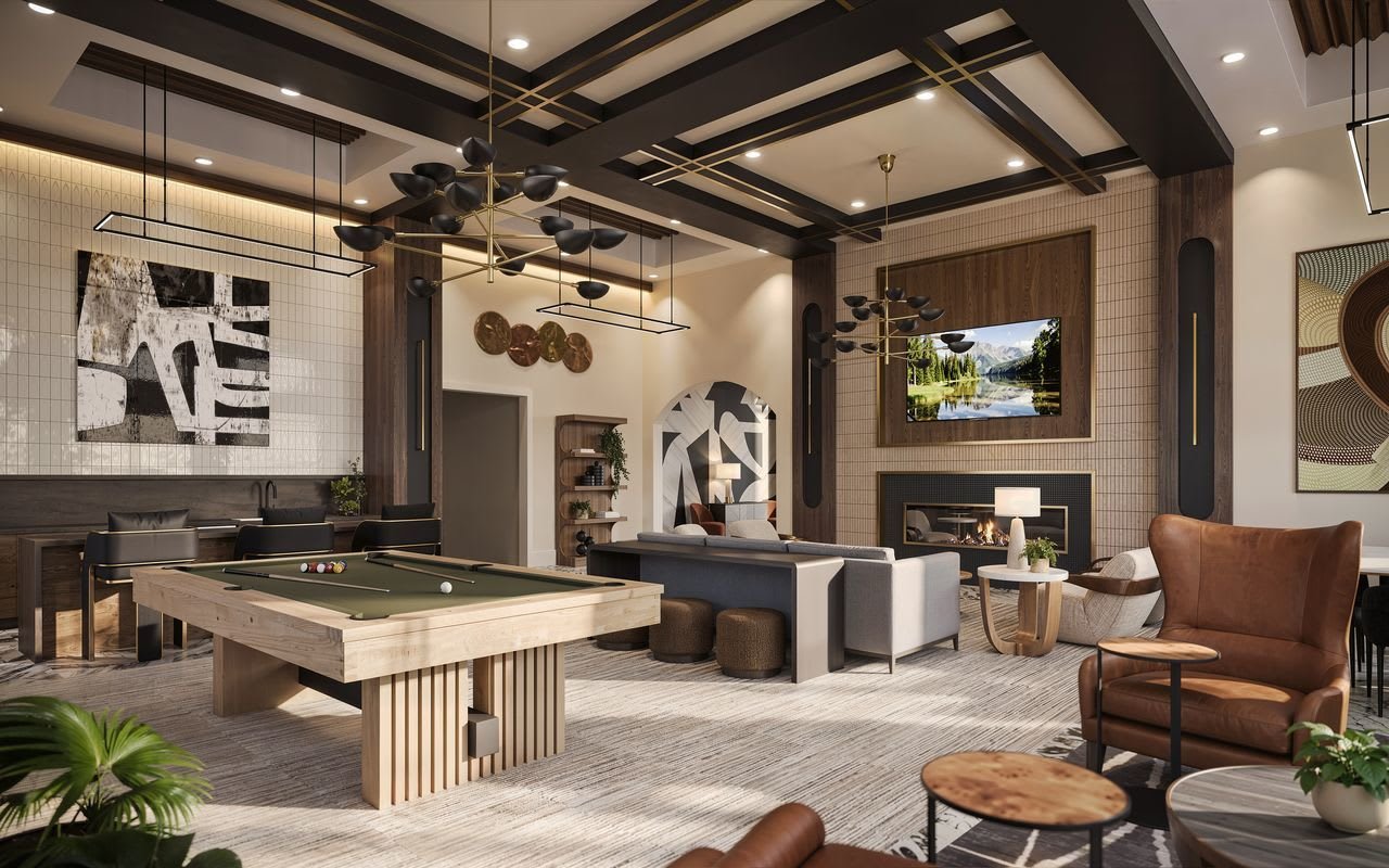 Clubhouse lounge with billiards table, fireplace, and leather seating