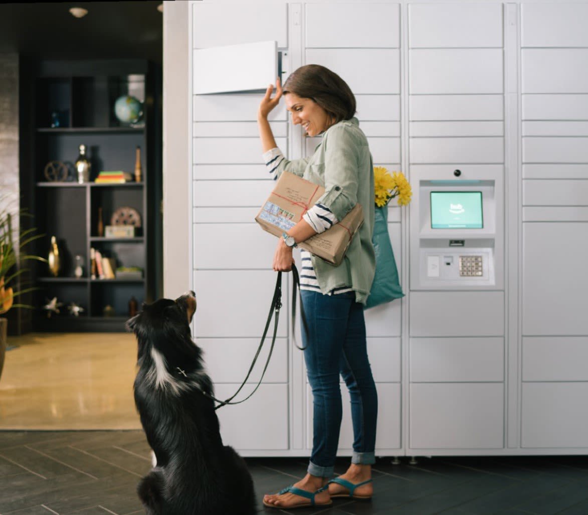 Resident picking up a package from the self-service locker wall