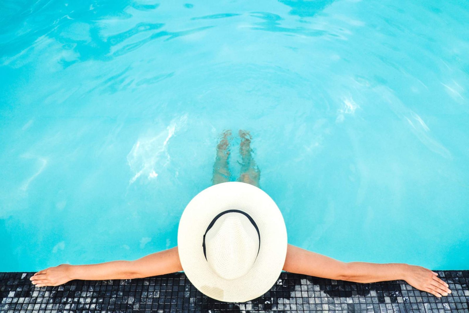 Overhead view of a swimmer relaxing at the edge of the heated pool
