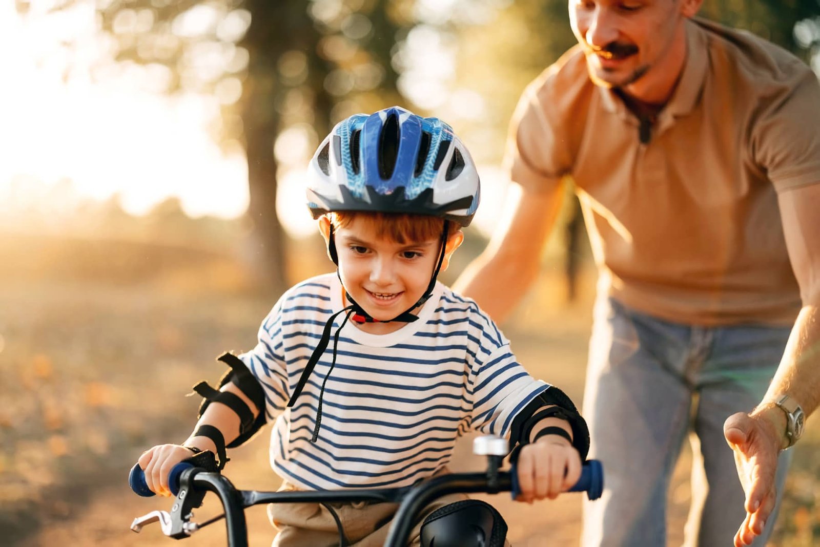 Cyclist riding along a scenic path near the community