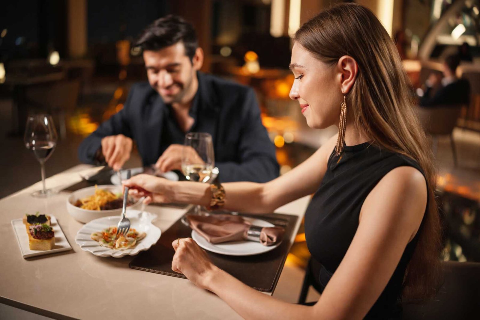 Couple enjoying a candlelit dinner at a downtown restaurant